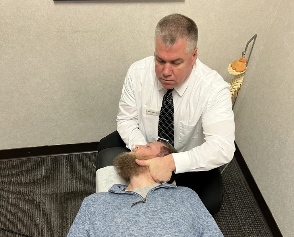 Dr. Tony Yannessa performing a cervical adjustment